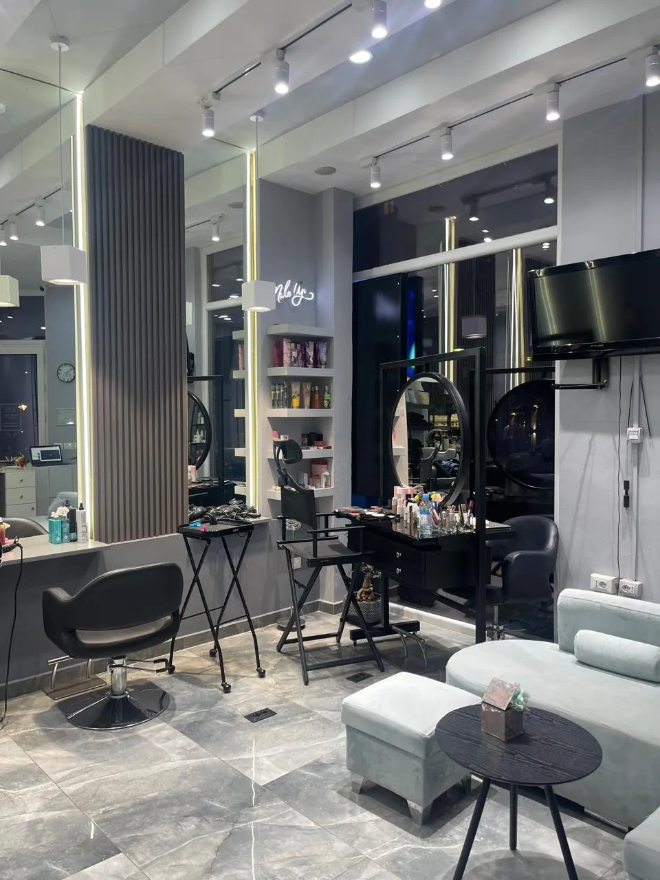 Inside the studio, with mirrors, styling chairs and a waiting corner