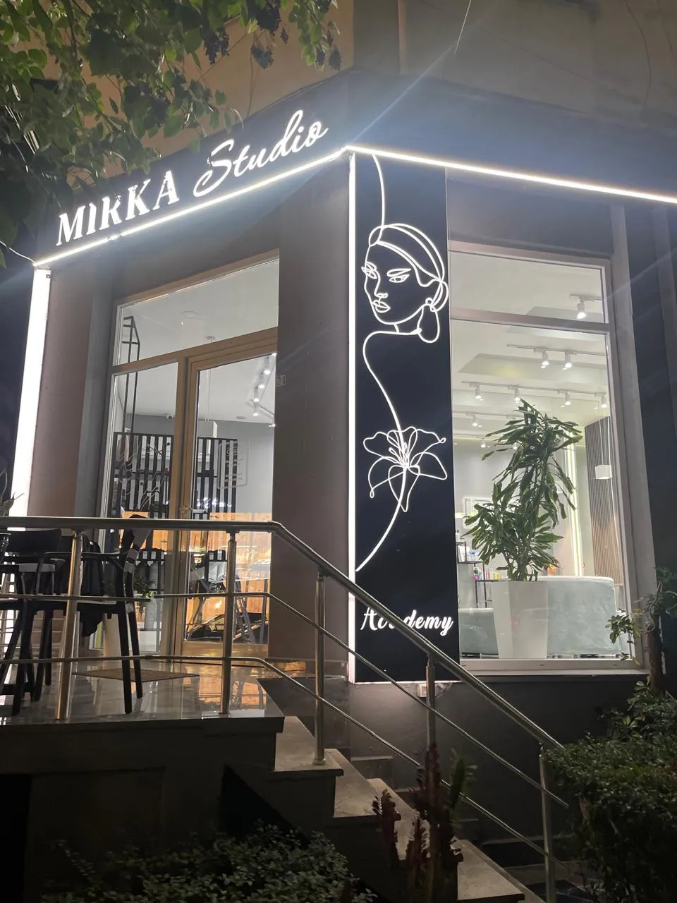 The Mirka Studio Academy entrance at night, with the lit sign